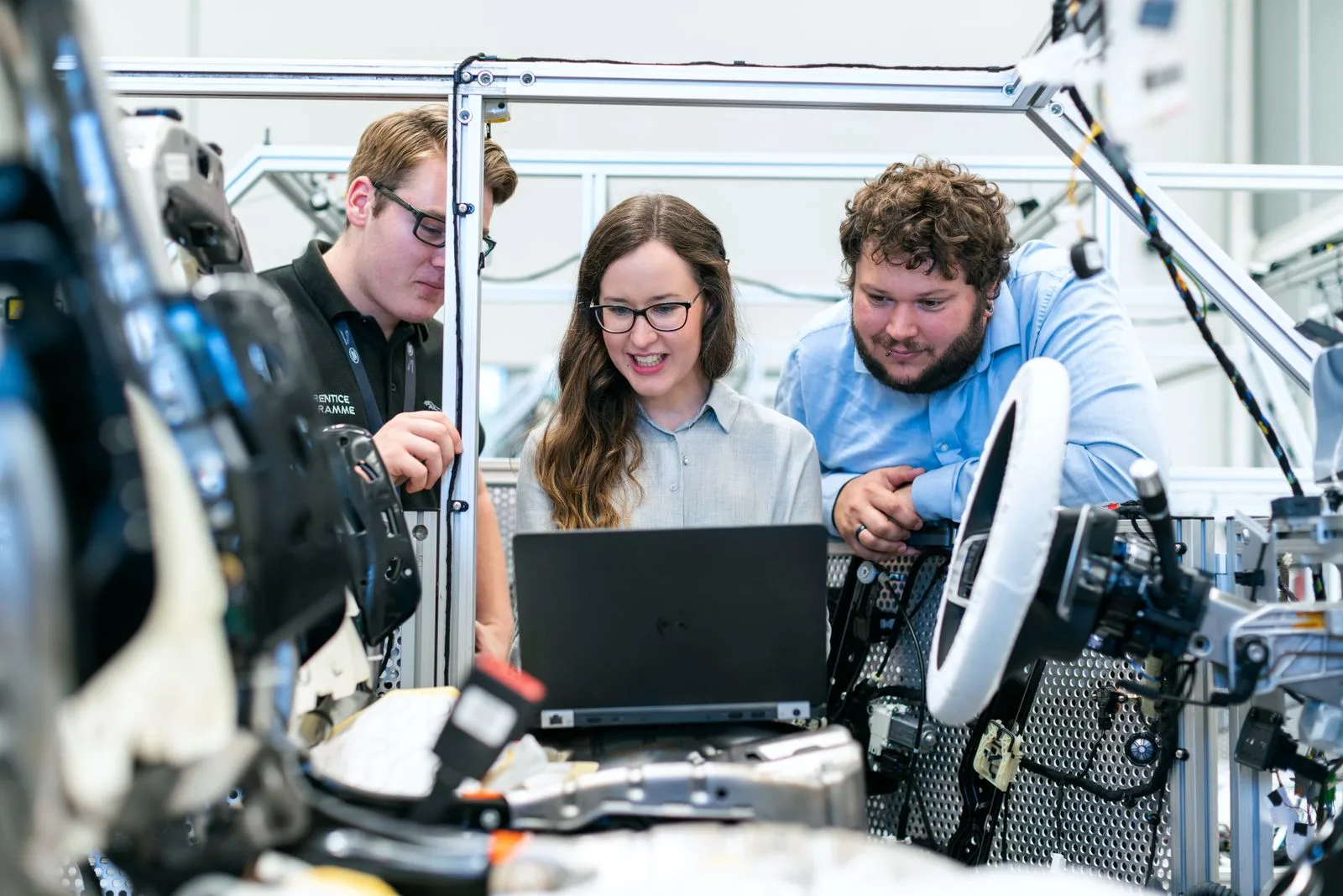 Physics and engineering tutors analysing mechanics lab data with a student