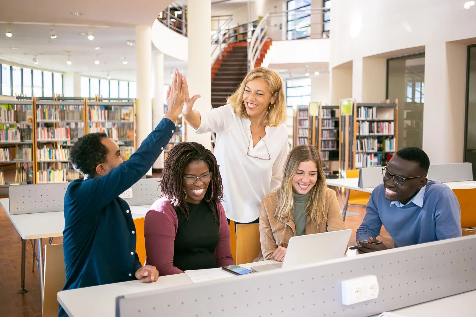 Qualified College Application Essays tutors - mentor celebrating progress with students during an essay coaching session