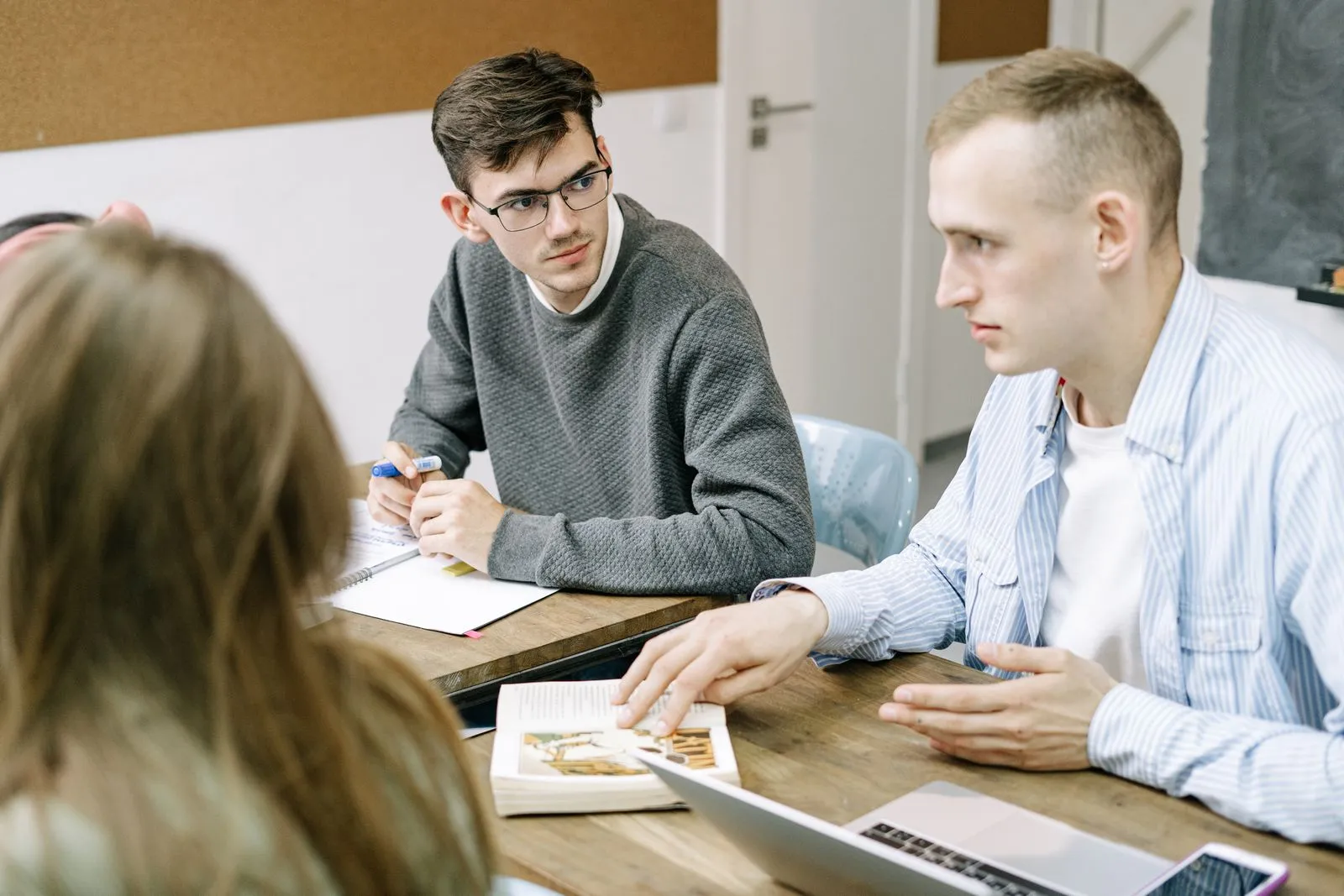 Qualified Linear Algebra tutors - instructor explaining concepts from a textbook during a study session