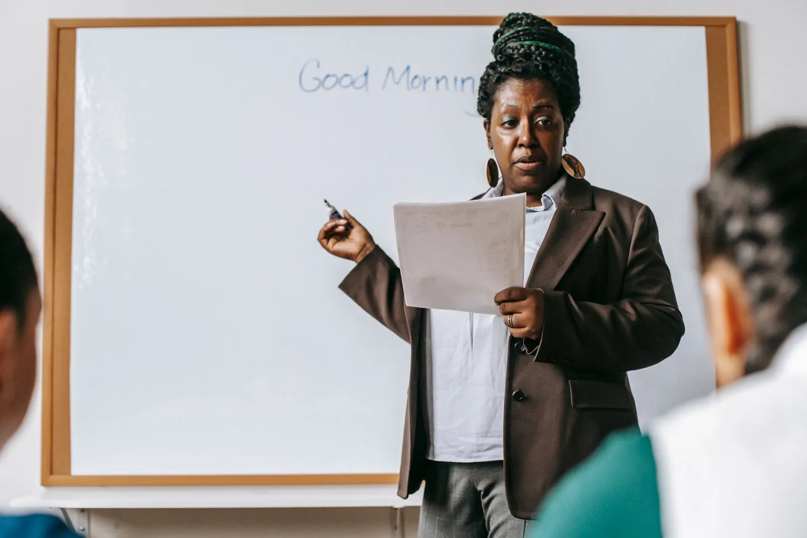 Qualified Narrative Writing tutors - instructor guiding students through writing on a whiteboard
